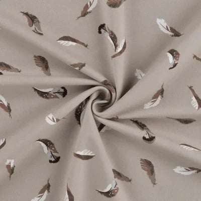 Jersey de coton  imprimé plumes fond sable